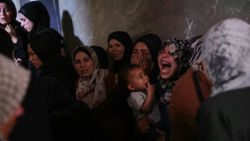 Palestinians mourn members of the Azzam family who were killed in Israeli attacks on their home in Jabalia in northern Gaza