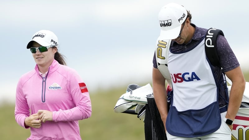 Leona Maguire and caddie Shane O'Connell walk to the 14th tee during the first round