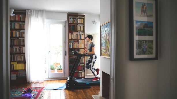 woman running on a treadmill in her living room