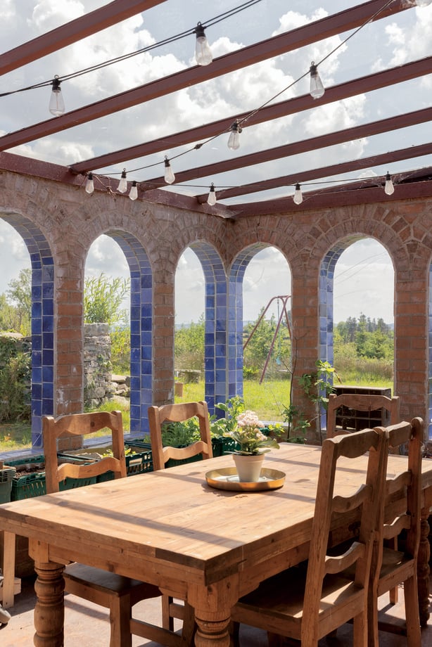 a table and chairs in a room with a glass roof