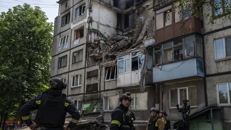 Firefighters from the Donetsk region work through the rubble after a Russian air strike