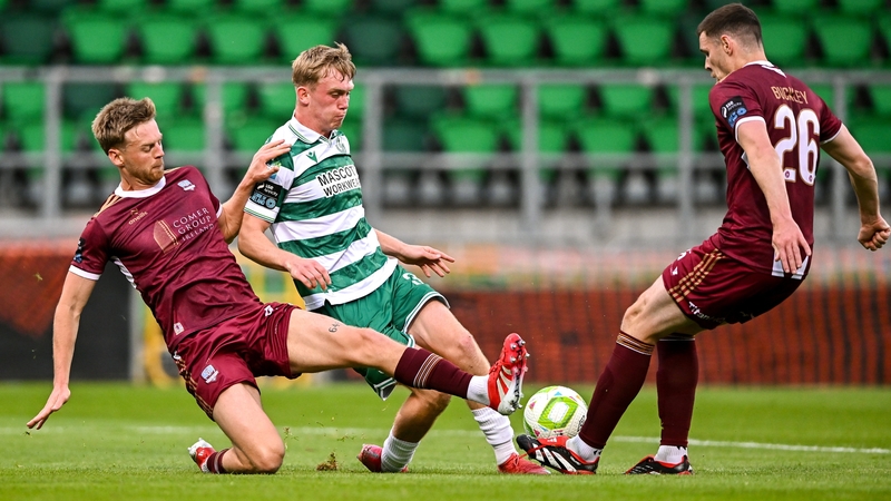 Shamrock Rovers' Michael Noonan is tackled by Robert Slevin (L) and Garry Buckley of Galway United