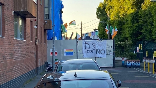 Under tricolours on Basin View lane protesters have hung a large banner which reads 'D8 says no'