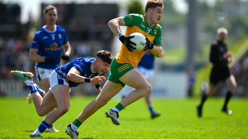 Ciarán Moore of Donegal races clear of Cian Reilly of Cavan