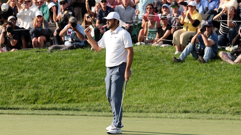 Scottie Scheffler celebrates after making par on the 18th green to win the Memorial Tournament
