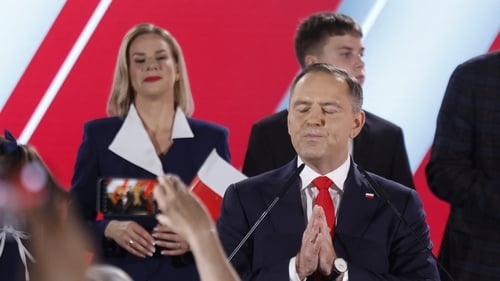 Karol Nawrocki gestures as he addresses his supporters following the release of exit polls in Poland's presidential election