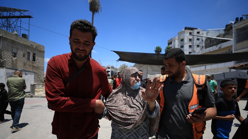 A woman is taken for treatment following an Israeli attack on a home in northern Gaza