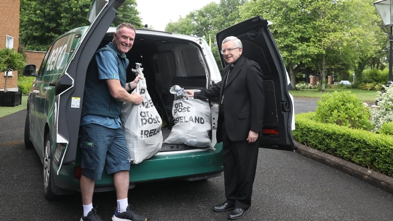 An Post postperson Mark O'Neill with Ireland's Apostolic Nuncio, Archbishop Luis Mariano Montemayor
