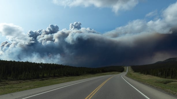 Wildfire smoke above Highway 97, north of the Buckinghorse River near Trutch, British Columbia, Canada, on Friday, May 30, 2025. Wildfires are threatening about 5% of Canada's crude output as a blaze in Alberta's oil sands region spreads and approaches major production sites. Photographer: Nasuna St