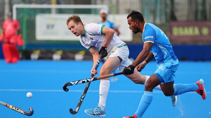 Ireland's Ben Pasley evades his Indian opposite number