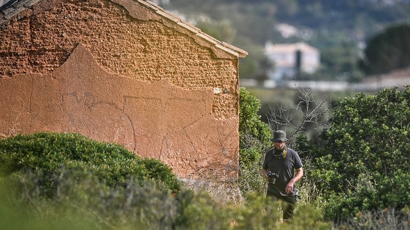 An investigator walks near an abandoned house during the new search operation