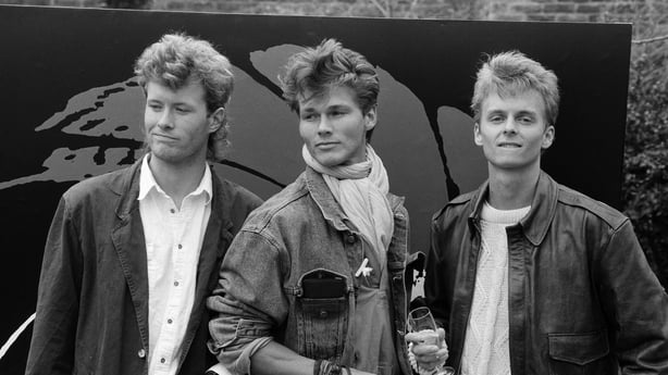Norwegian pop trio A-ha are set to record the title song for the forthcoming James Bond film "The Living Daylights". They are pictured with some of the latest bond girls at Kensington Palace Gardens, London, 30th March 1987. (Photo by Peter Stone/Daily Mirror/Mirrorpix via Getty Images)
