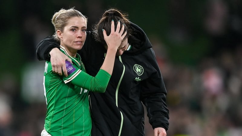 Denise O'Sullivan (L) consoles Niamh Fahey after the defeat to Wales