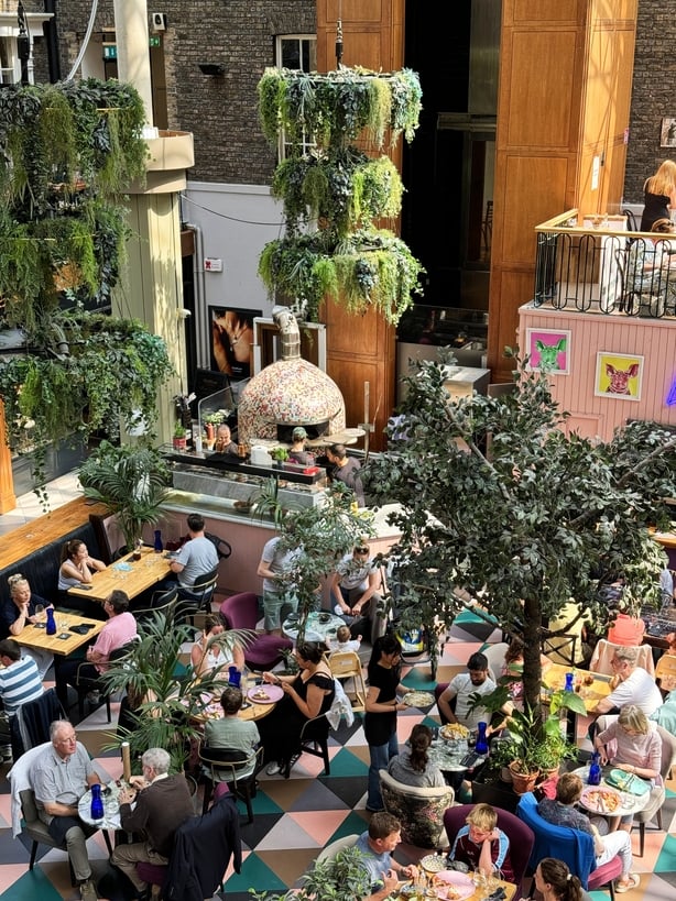 a group of people sitting at tables in a restaurant