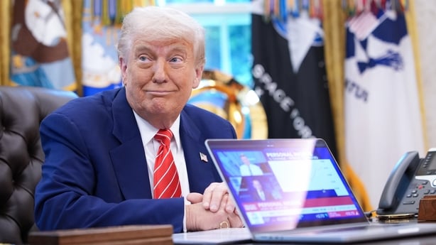 WASHINGTON, DC - MAY 30: U.S. President Donald Trump, joined by Tesla CEO Elon Musk, shows a news video from a laptop in the Oval Office of the White House on May 30, 2025 in Washington, DC. Musk, who served as an adviser to Trump and led the Department of Government Efficiency, announced he would l