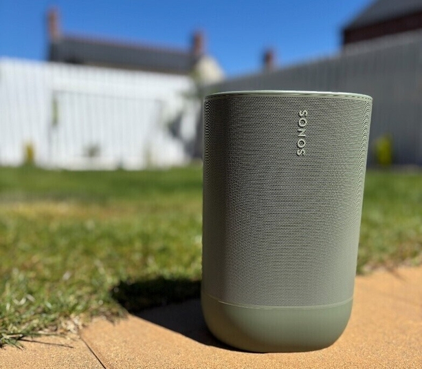 a grey speaker on a sidewalk