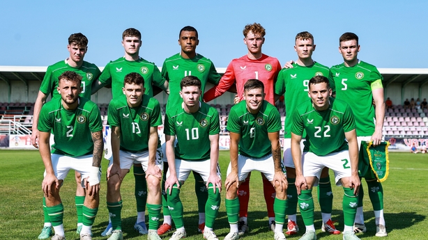 a group of men in green uniforms