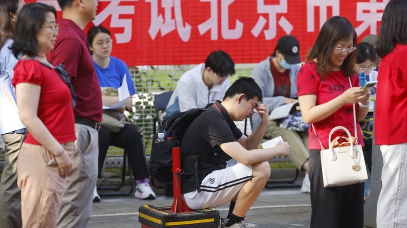 BEIJING, CHINA - JUNE 07: Students do last-minute review on their way to a national college entrance examination site on June 7, 2025 in Beijing, China. China's 2025 national college entrance exam, also known as the gaokao, kicks off on June 7, with 13.35