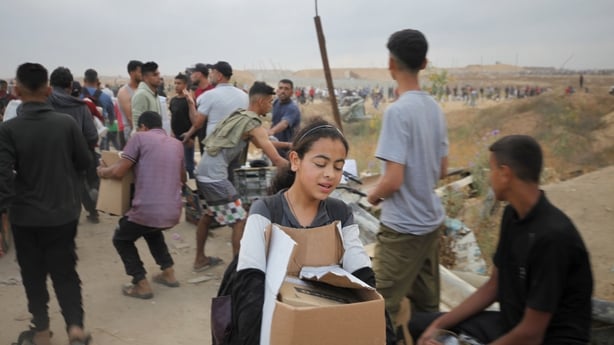 GAZA CITY, GAZA - JUNE 08: Palestinians flock to the aid distribution point in the Netzarim Corridor in the central Gaza Strip on June 8, 2025. Palestinians, who had been under an Israeli blockade for months, returned home with the small amount of aid they were able to receive. (Photo by Moiz Salhi/