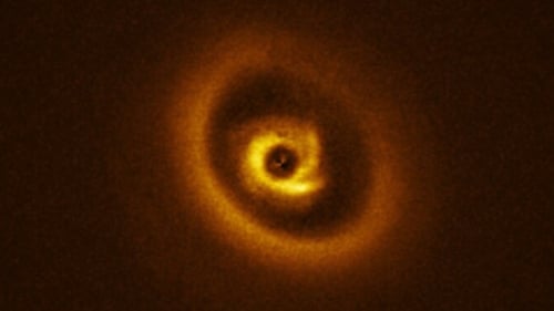 Resembling a hurricane on Earth, a system of spiral arms are visible in the image