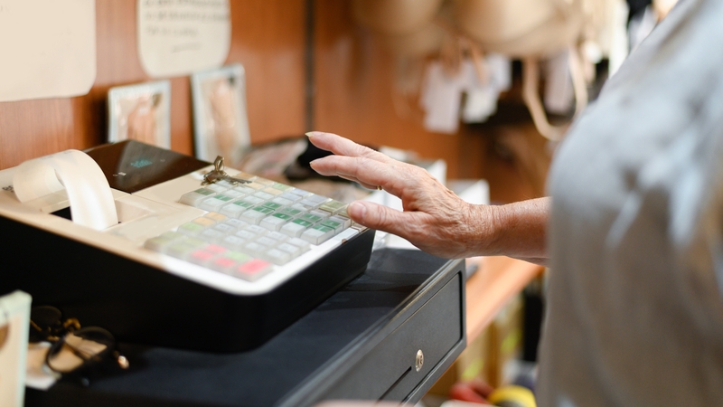 Close up of old woman hand on the cash register, Female hand on the cash register in a store.