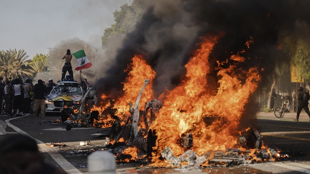 LOS ANGELES, CALIFORNIA - JUNE 8: Several cars burn on North Los Angeles street during clashes between protesters and police on June 8, 2025 in Downtown Los Angeles, California. The clashes come after ICE raids swept throughout the city over the weekend. (Photo by Jim Vondruska/Getty Images)