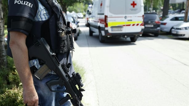 A policeman is seen next to an ambulance car close to a school where, according to reports, several people died in a shooting, on June 10, 2025 in Graz, southeastern Austria. Several people died in a school shooting, including the attacker, Austrian broadcaster ORF quoted the interior ministry as sa