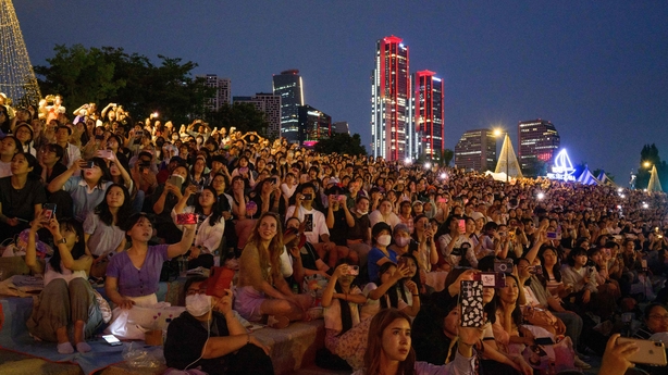 Fans of K-pop megastars BTS watch a firework display during the "BTS 10th Anniversary FESTA @ Yeouido" in Seoul on June 17, 2023, to mark the 10th anniversary of the group's debut. (Photo by ANTHONY WALLACE / AFP) (Photo by ANTHONY WALLACE/AFP via Getty Images)