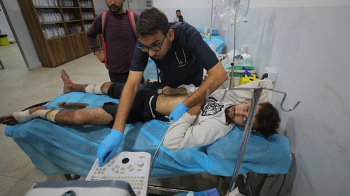 A Palestinian man who was injured in an Israeli attack on Nuseirat camp receives medical treatment at Al Awda Hospital in Jabalia, Gaza