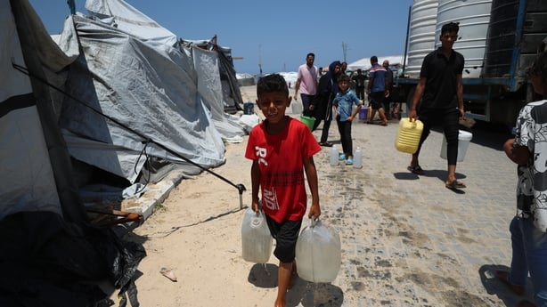 GAZA CITY, GAZA - JUNE 11: Displaced Palestinians in Gaza transport water delivered by tankers to their tents, filling it into containers to meet their daily needs in Gaza City, Gaza on June 11, 2025. In the Gaza Strip, Palestinians deprived of basic necessities such as shelter, food, and clean wate