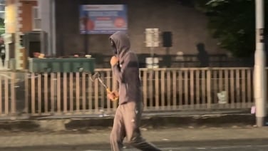 A hatchet was thrown at police during a third night of disorder in Northern Ireland