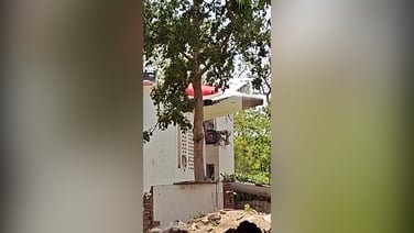 Airplane fragment sticks out from building