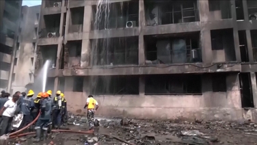 Emergency workers extinguish fires in wreckage of Air India plane crash