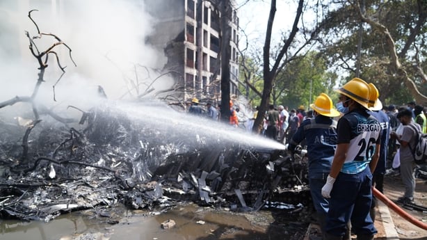 Emergency service workers douse wreckage at the crash site of Air India Ltd. flight AI171 in Ahmedabad, Gujarat, India, on Thursday, June 12, 2025. An Air India Boeing 787 Dreamliner traveling from Ahmedabad to London's Gatwick airport crashed shortly after taking off, in what stands to be the most 