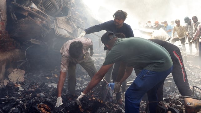 Rescue officials work at the site where Air India flight 171 crashed