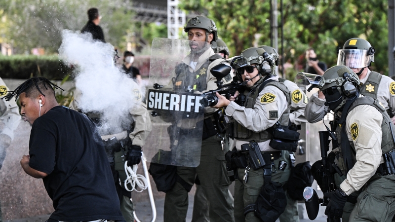 A police officer pictured firing a non-lethal round at a protester after demonstration against federal immigration operations in LA