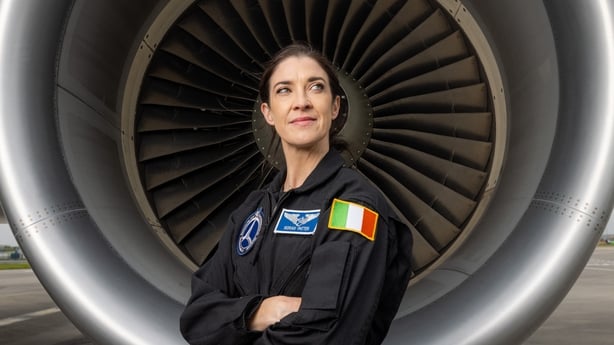 Dr Norah Patten standing in front of a plane