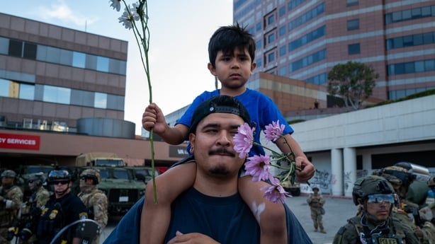 LOS ANGELES, CALIFORNIA - JUNE 13: A family, protesting, confronts law enforcement outside of a federal building and Immigration and Customs Enforcement (ICE) detention center on June 13, 2025, in Los Angeles, California. Demonstrations continue after a series of immigration raids began last Friday,