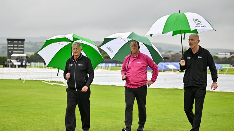 Umpires, from left, Mark Hawthorne, Aidan Seaver and Johnny Kennedy inspect the pitch before abandoning match two