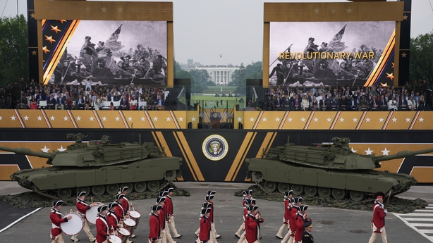 WASHINGTON, DC - JUNE 14: U.S. President Donald Trump and guests watch as members of the U.S Army parade down Constitution Avenue marking the 250th birthday of the U.S. Army June 14, 2025 in Washington, DC. The U.S. Army is marking its 250th birthday with a military parade including roughly 6,600 tr