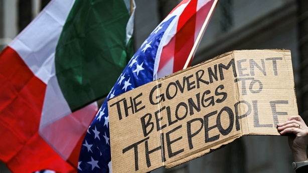 People take part in a "No Kings" protest outside City Hall in Los Angeles, California, on June 14, 2025 as US President Donald Trump presides over a military parade in Washington, DC. Trump will preside over a huge military parade in Washington on his 79th birthday, as nationwide protests rejecting