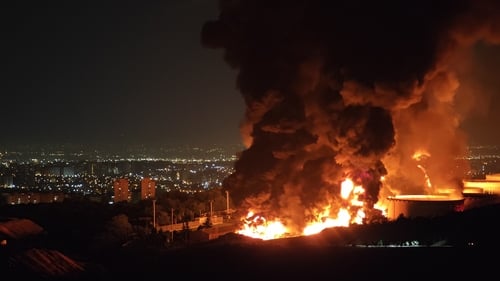Fire and smoke rise into the sky after an Israeli attack on the Shahran oil depot in Tehran, Iran