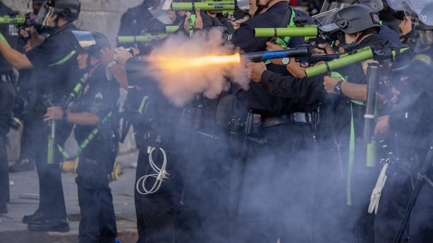 LOS ANGELES, CALIFORNIA - JUNE 14: Police officers repeatedly shoot people with less-than-lethal munitions during a "No Kings" movement protest in the one-square mile area where daily protests have been occurring in response to a series of federal immigration raids on June 14, 2025 in Los Angeles, C
