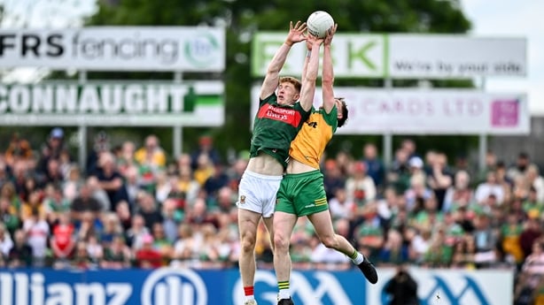 15 June 2025; David McBrien of Mayo in action against Ciaran Thompson of Donegal during the GAA Football All-Ireland Senior Championship Round 3 match between Donegal and Mayo at King & Moffatt Dr Hyde Park in Roscommon. Photo by Seb Daly/Sportsfile
