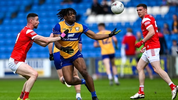 Ikem Ugweuru of Clare is tackled by Ciaran Downey of Louth during the GAA Football All-Ireland Senior Championship Round 3 match between Louth and Clare at Laois Hire O'Moore Park in Portlaoise, Laois.