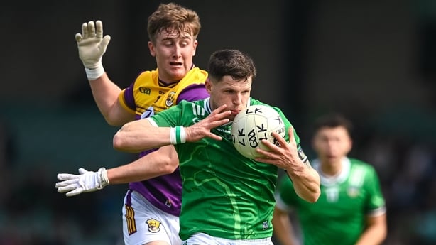 15 June 2025; Iain Corbett of Limerick is tackled by Jack Higgins of Wexford during the Tailteann Cup quarter-final match between Limerick and Wexford at TUS Gaelic Grounds in Limerick. Photo by Tom Beary/Sportsfile