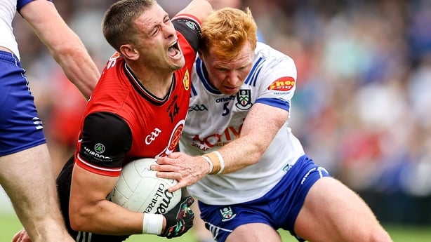 Pat Havern of Down is tackled by Ryan O'Toole of Monaghan during the GAA Football All-Ireland Senior Championship Round 3 match between Monaghan and Down at BOX-IT Athletic Grounds in Armagh.