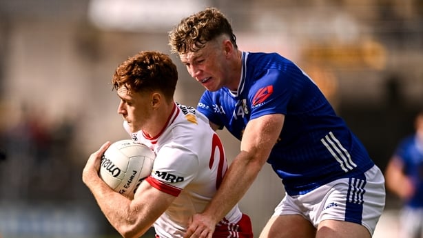 15 June 2025; Conor Meyler of Tyrone is tackled by Paddy Lynch of Cavan during the GAA Football All-Ireland Senior Championship Round 3 match between Tyrone and Cavan at Brewster Park in Enniskillen, Fermanagh. Photo by Ben McShane/Sportsfile