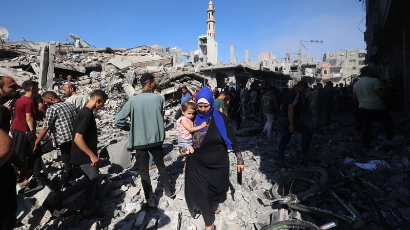 Palestinians inspect the rubble of a house hit by an Israeli strike on the Bureij camp for refugees in central Gaza