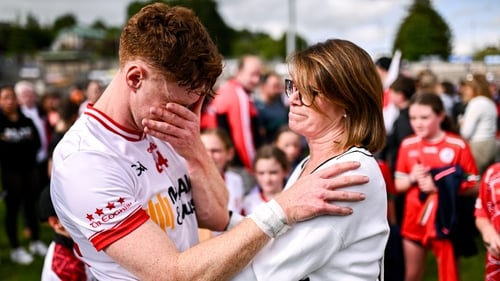 An emotional Conor Meyler of Tyrone is consoled by his mother Paula